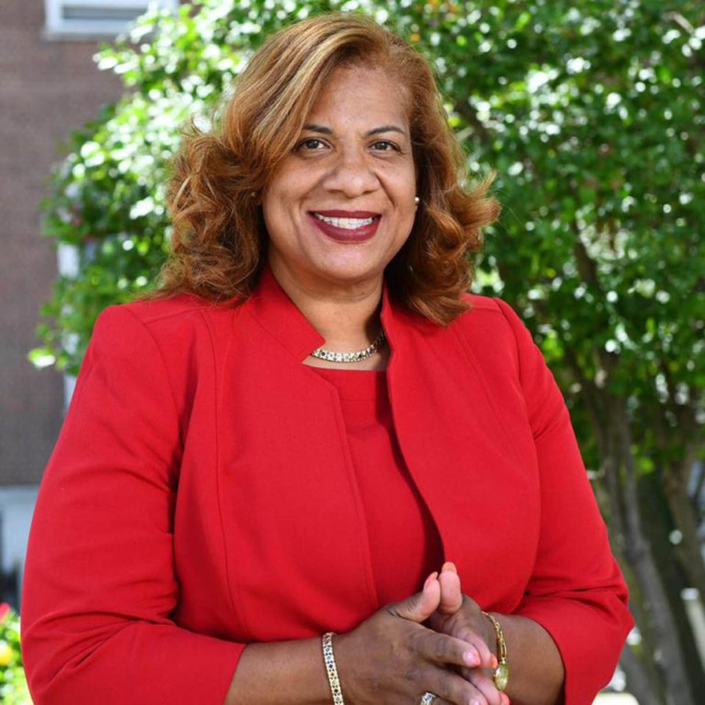 Headshot of Mayor Patterson-Howard, who wears a red jacket and shirt and has shoulder-length light brown hair.