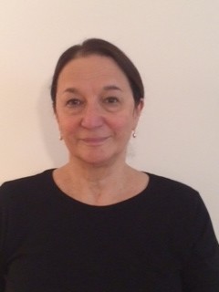 Headshot of Rosalyn Deutsche who wears a black shirt.
