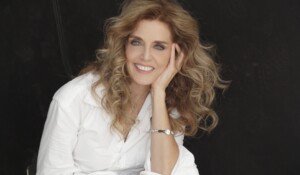 Gina Angelone headshot in color against black background