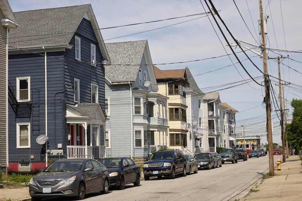 The exterior of a row of houses on a residential street.