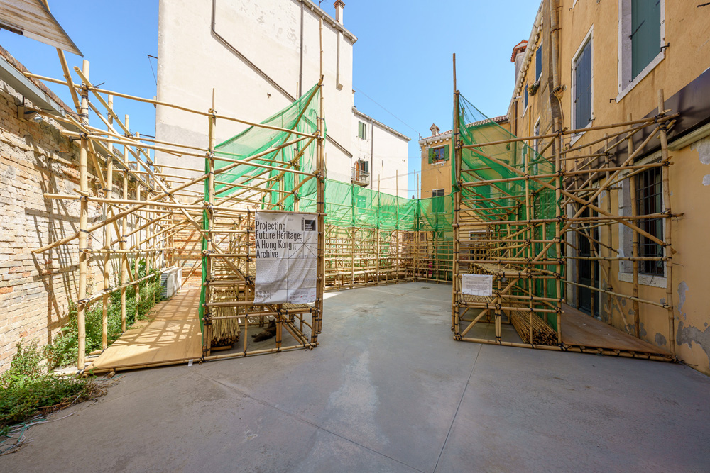 Old courtyard with bamboo scaffolding on three sides.