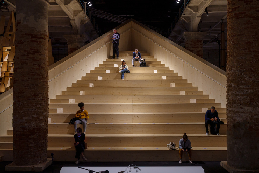 Triangular wooden grandstand rising amid brick columns.